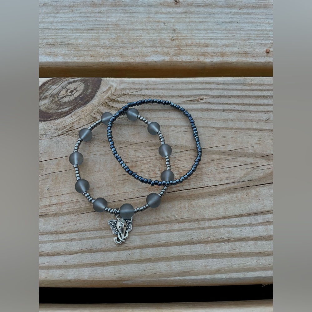Two Elephant theme beaded bracelets,one with a charm. Same size and gray/silver.